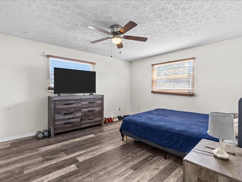 1297 Southeast Floresta Drive Port St. Lucie, FL 34983 - Photo 14 of 42 a bedroom with furniture and a flat screen tv