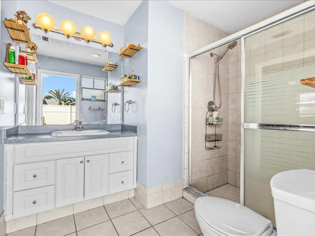 a bedroom with a bed and a wooden floor