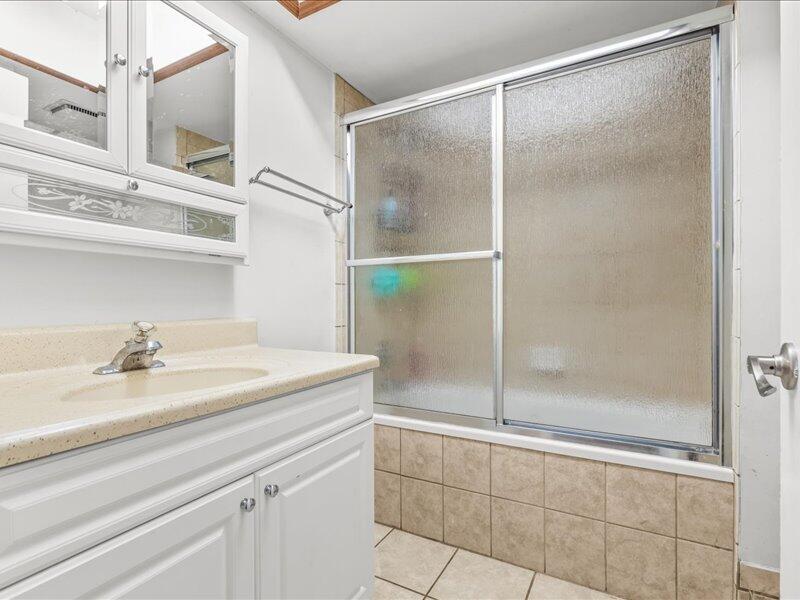 1297 Southeast Floresta Drive Port St. Lucie, FL 34983 - Photo 21 of 42 a bathroom with a shower and a sink