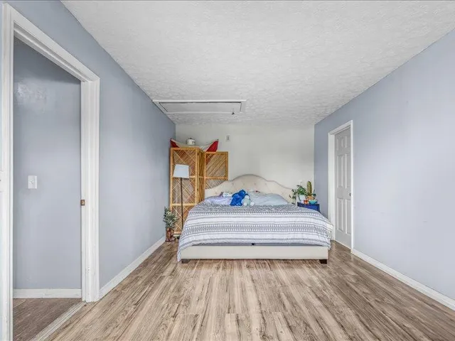 a view of a backyard with chairs and a barbeque