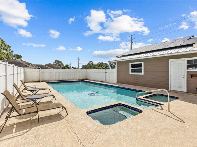 1297 Southeast Floresta Drive Port St. Lucie, FL 34983 - Photo 28 of 42 a view of a backyard with chairs and a barbeque