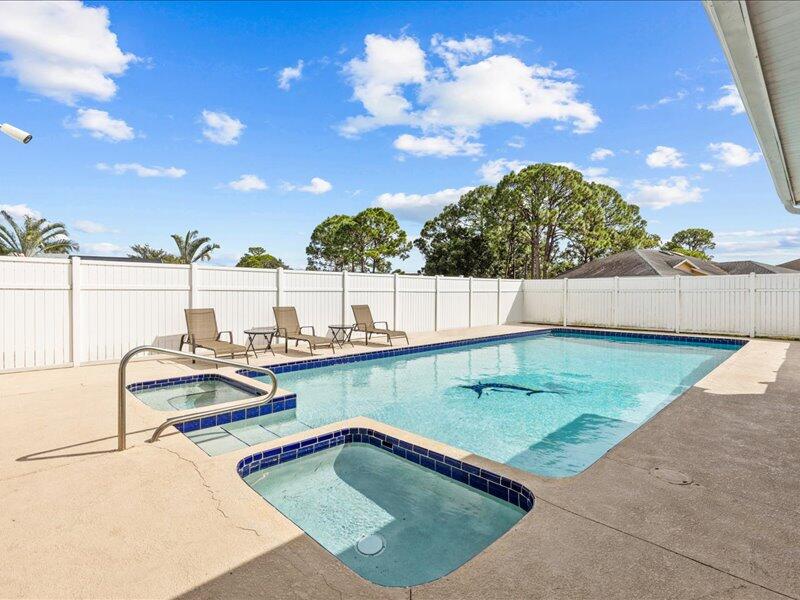 1297 Southeast Floresta Drive Port St. Lucie, FL 34983 - Photo 30 of 42 a view of a swimming pool with outdoor seating and plants