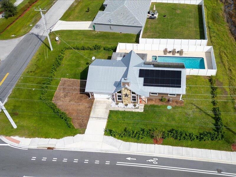 1297 Southeast Floresta Drive Port St. Lucie, FL 34983 - Photo 36 of 42 an aerial view of a house with a yard and a garden