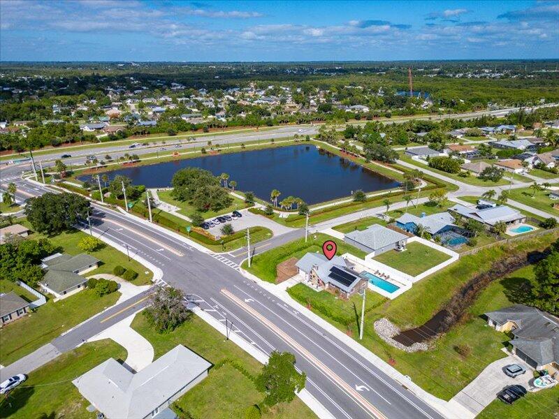 1297 Southeast Floresta Drive Port St. Lucie, FL 34983 - Photo 40 of 42 an aerial view of a resort with a lawn chairs