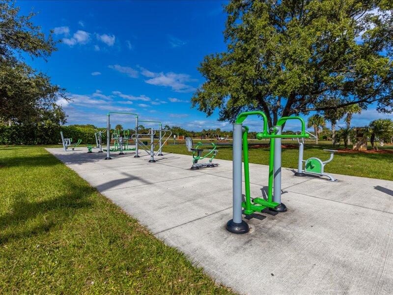 1297 Southeast Floresta Drive Port St. Lucie, FL 34983 - Photo 42 of 42 a view of a park with swings and slides