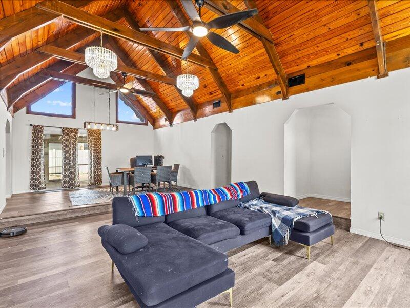 1297 Southeast Floresta Drive Port St. Lucie, FL 34983 - Photo 6 of 42 a living room with furniture and a chandelier