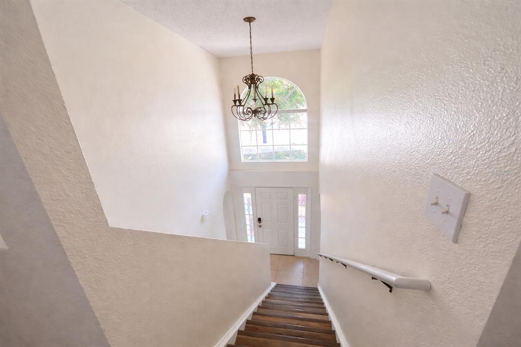 704 Swan Way Kissimmee, FL 34758 - Photo 11 of 15 a view of a hallway with windows