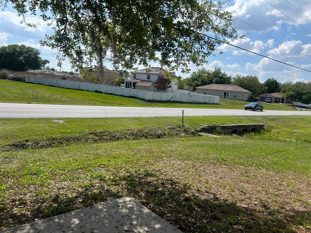 704 Swan Way Kissimmee, FL 34758 - Photo 15 of 15 a view of an outdoor space and a yard