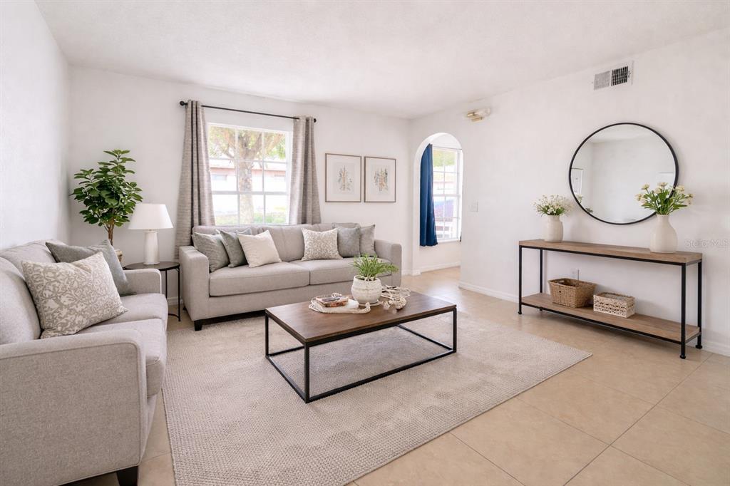 704 Swan Way Kissimmee, FL 34758 - Photo 2 of 15 a living room with furniture a window and a fireplace