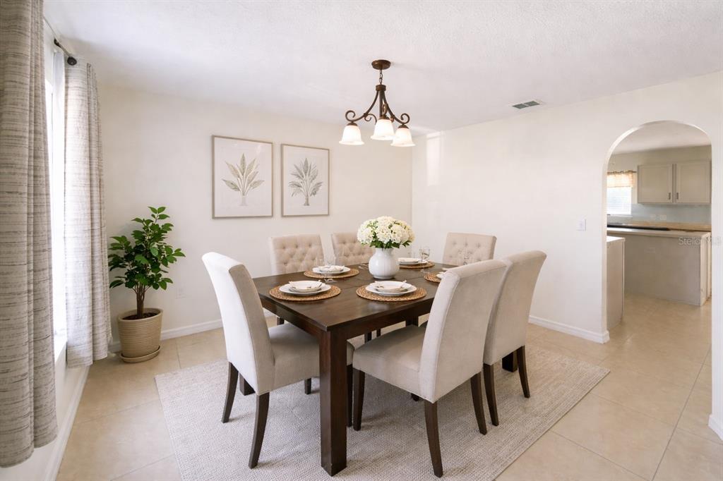 704 Swan Way Kissimmee, FL 34758 - Photo 3 of 15 a view of a dining room with furniture and window