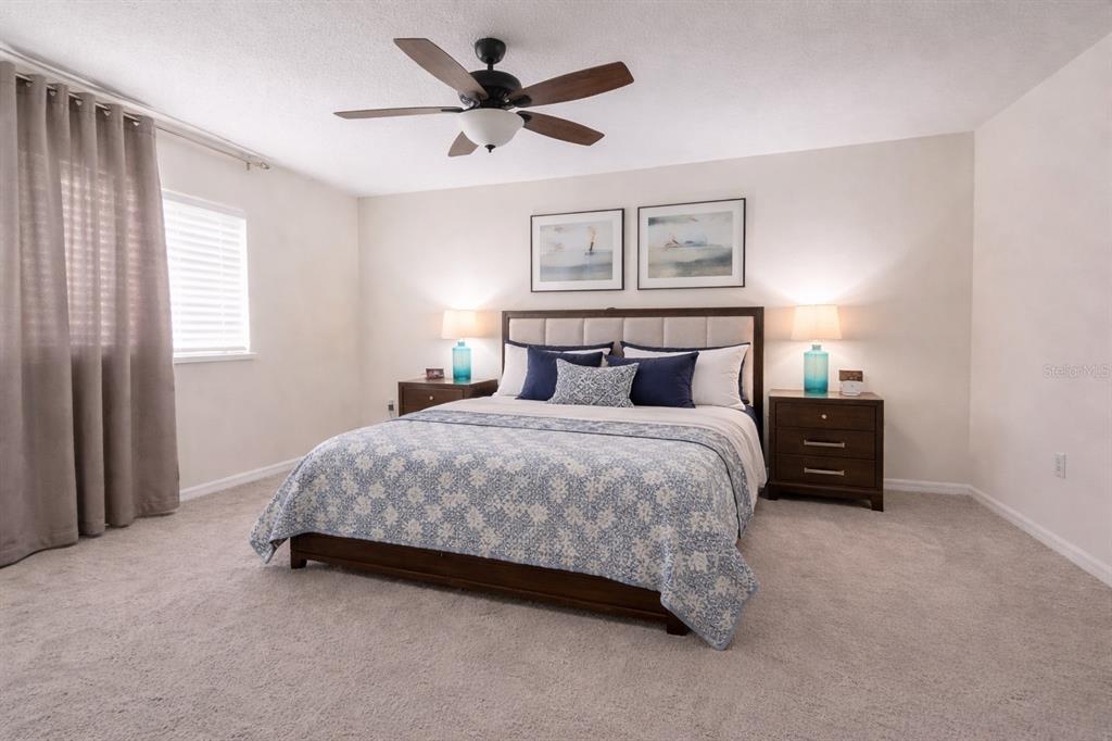 704 Swan Way Kissimmee, FL 34758 - Photo 5 of 15 a bedroom with a bed and a tv