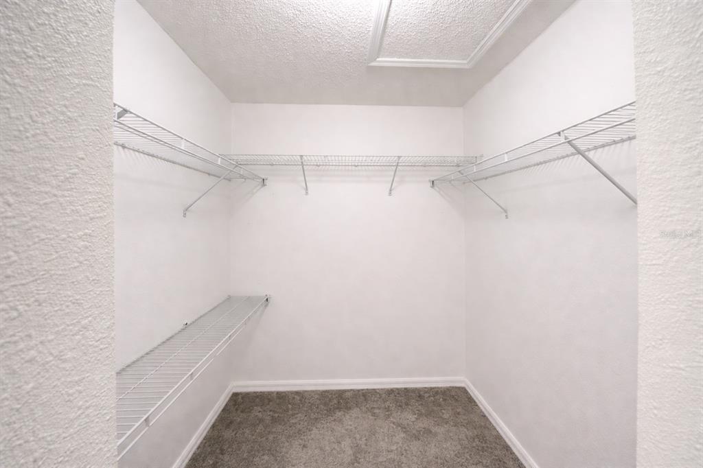 704 Swan Way Kissimmee, FL 34758 - Photo 6 of 15 a view of a room with racks on the wall