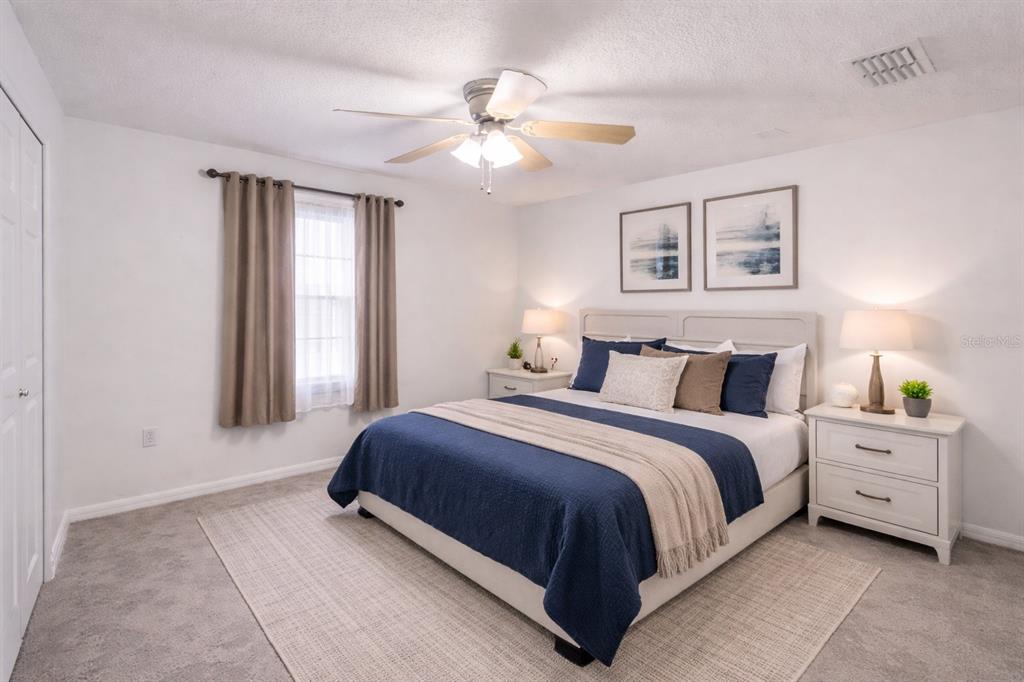 704 Swan Way Kissimmee, FL 34758 - Photo 8 of 15 a bedroom with bed and window