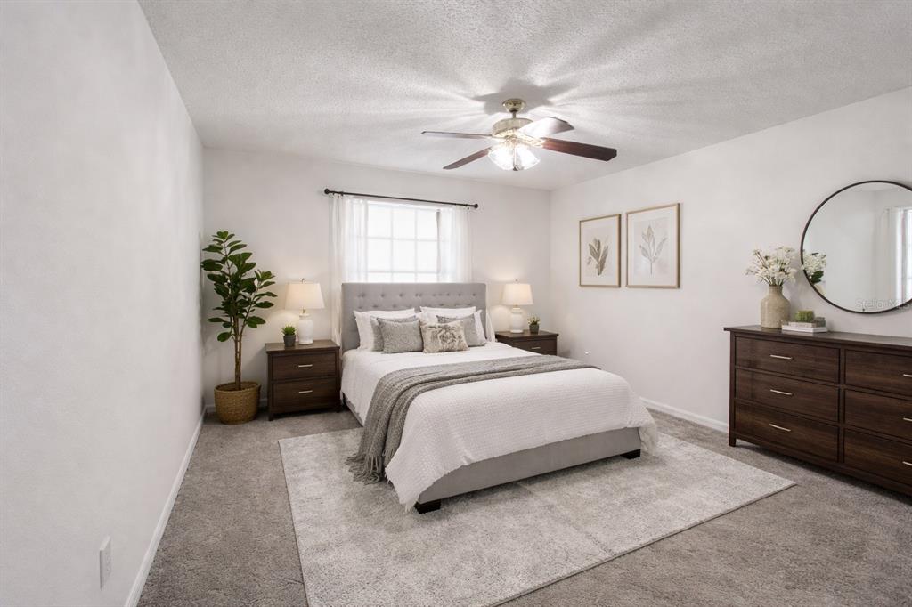 704 Swan Way Kissimmee, FL 34758 - Photo 9 of 15 a bedroom with a bed and a dresser