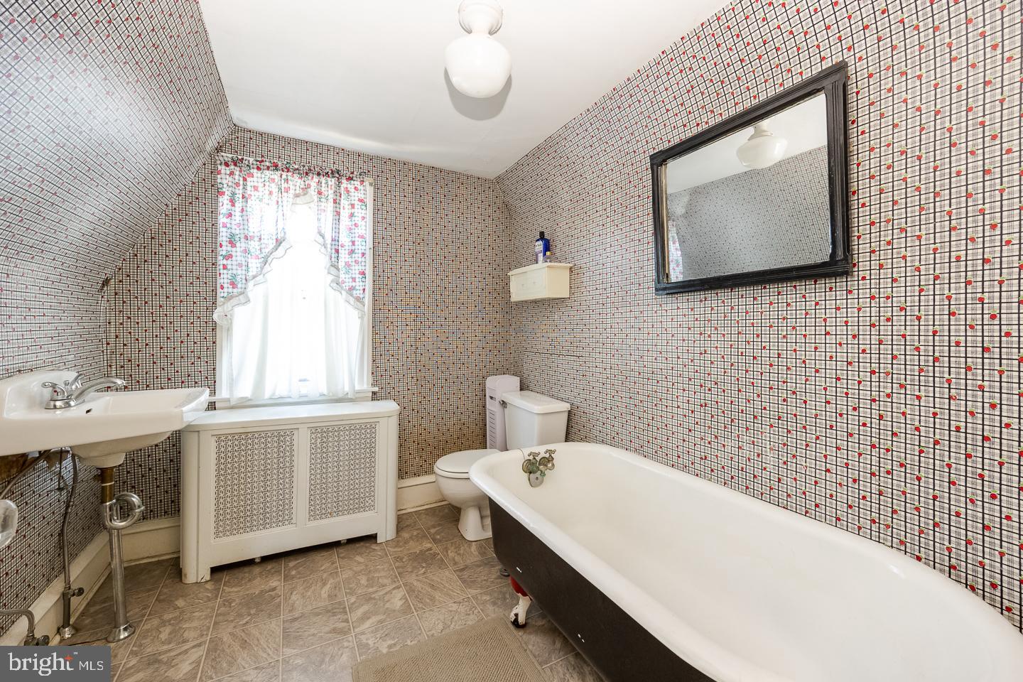 107 Crestview Road Upper Darby, PA 19082 - Photo 18 of 21 a bathroom with a sink mirror and a bathtub