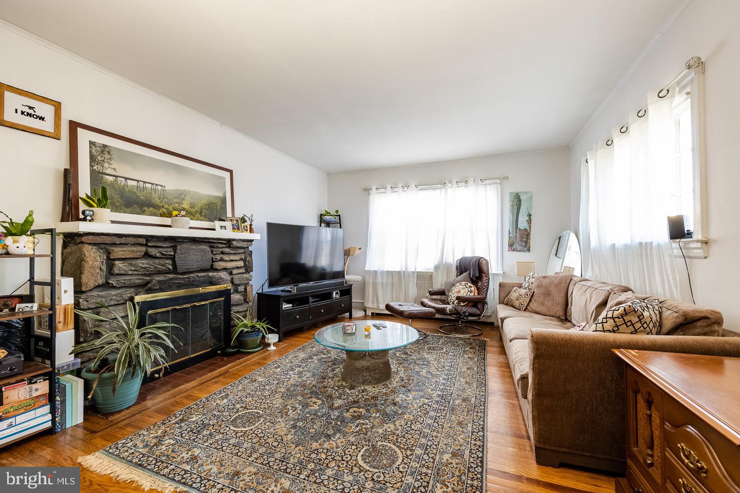 107 Crestview Road Upper Darby, PA 19082 - Photo 2 of 21 a living room with furniture a flat screen tv and a table