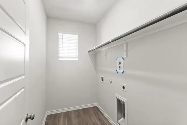 a view of hallway with window and wooden floor