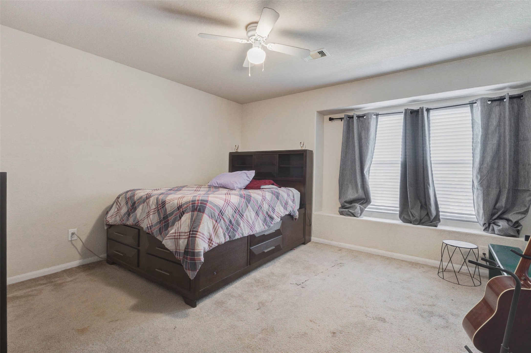 3027 Upland Spring Trace Katy, TX 77493 - Photo 20 of 29 a bedroom with a bed lamp and a large window