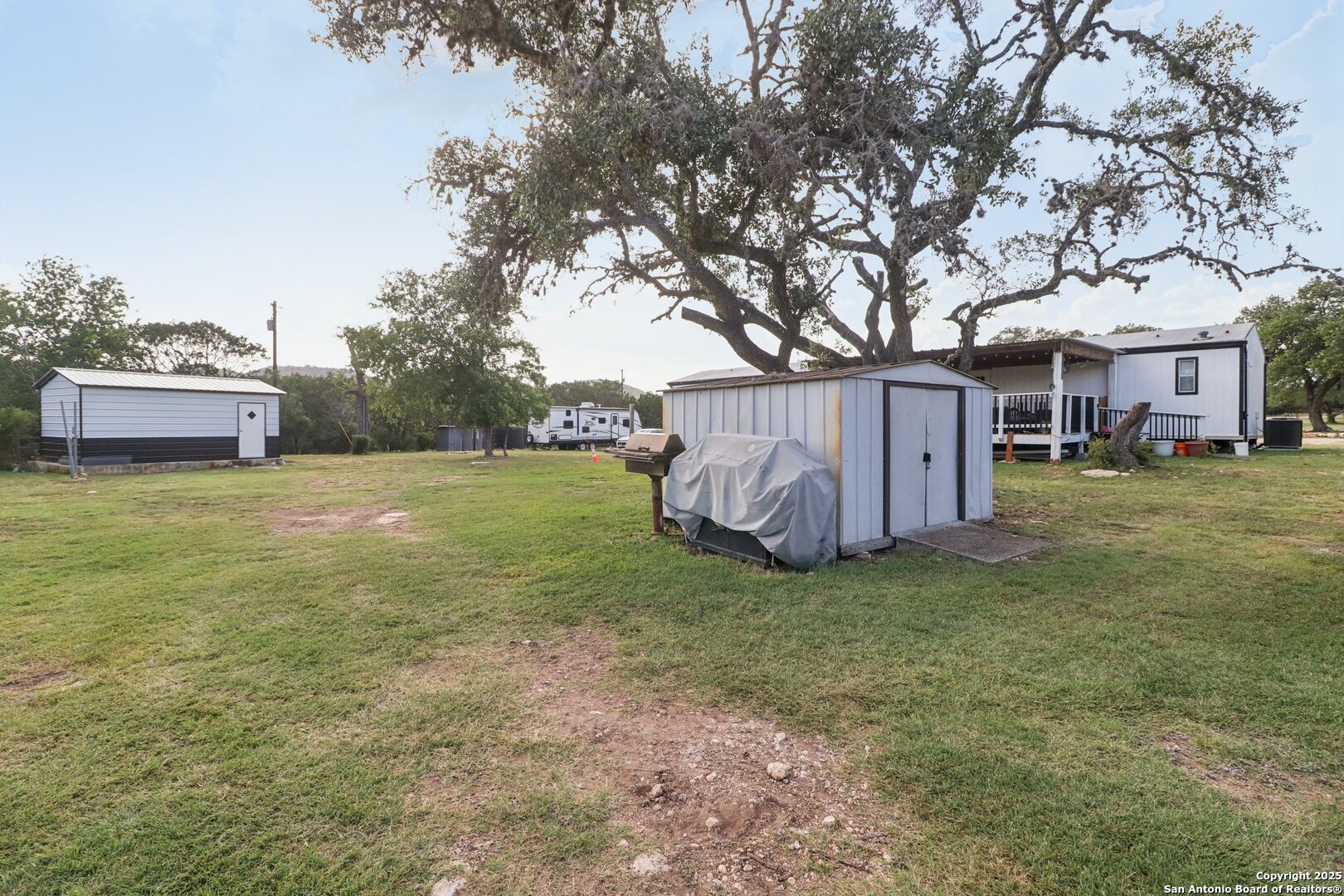 160 Deer View Road Pipe Creek, TX 78063 - Photo 32 of 55 a house view with a sitting space and garden