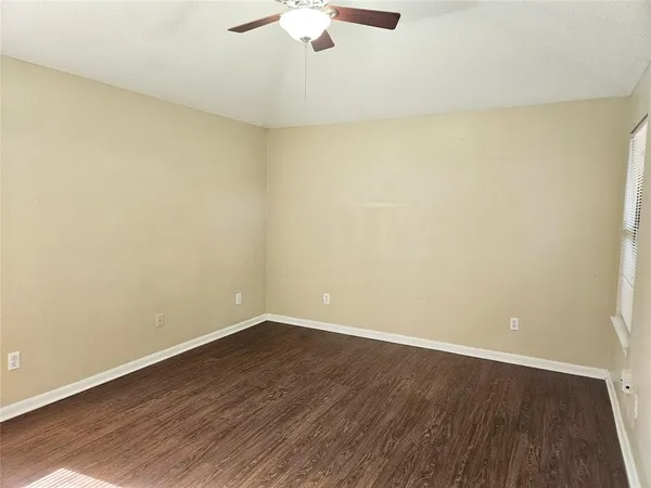 a view of a room with wooden floor