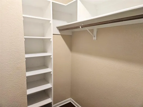 a view of an empty walk in closet
