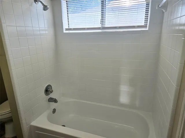 a bedroom with bed and a window