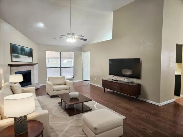 a living room with furniture flat screen tv and a fireplace