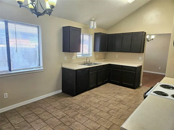a kitchen with stainless steel appliances a sink and cabinets