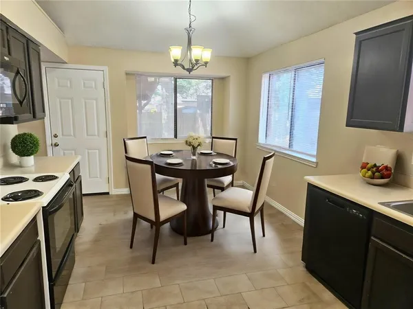 a dining room with furniture and window