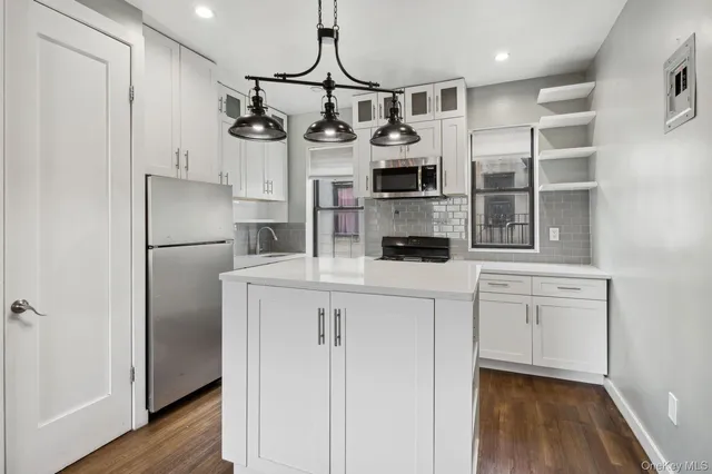 a kitchen with cabinets and stainless steel appliances