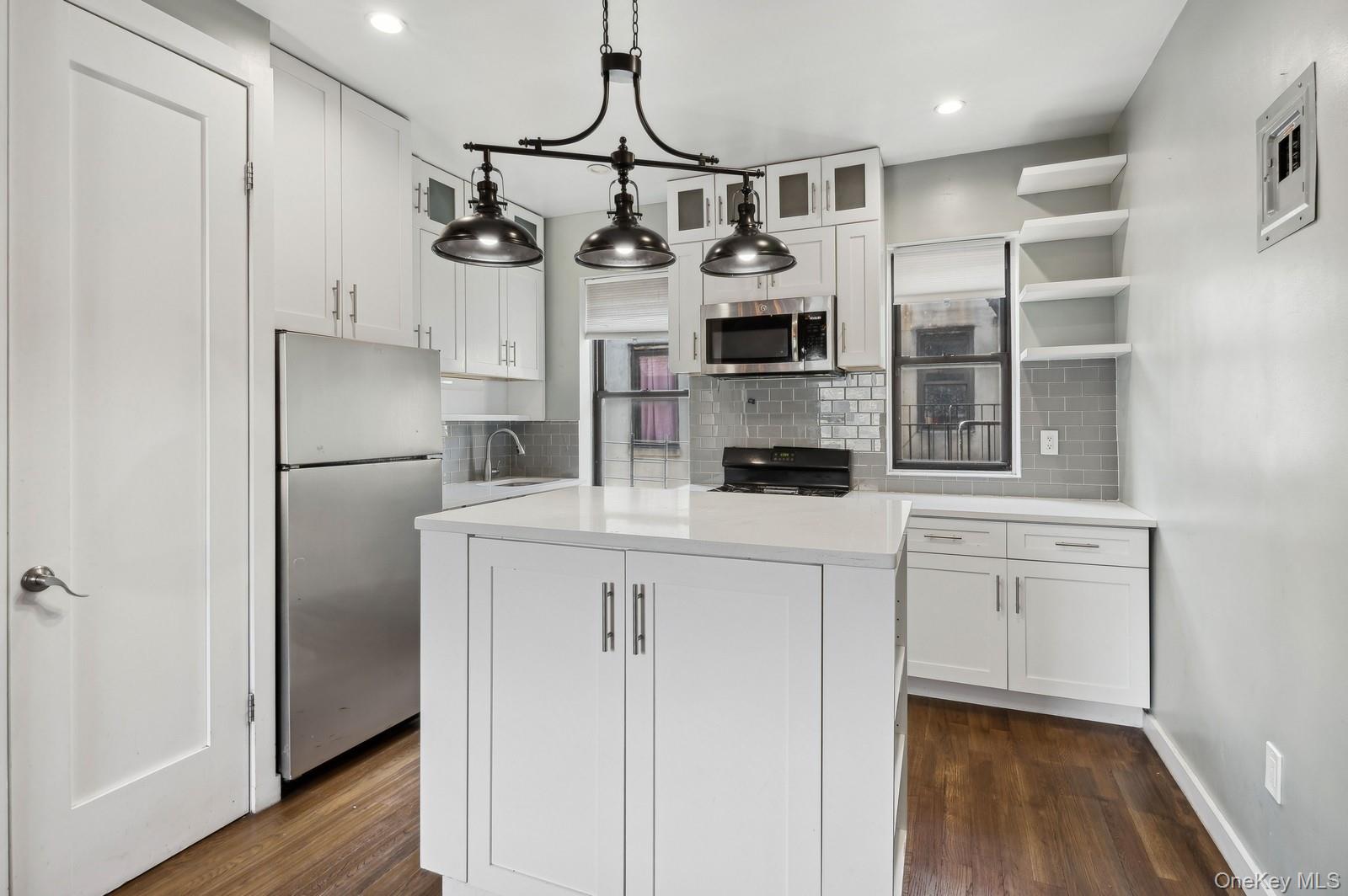a kitchen with cabinets and stainless steel appliances