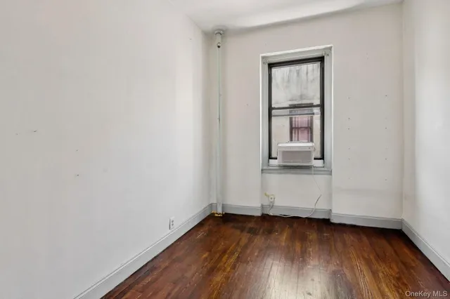 a view of a room that has wooden floor and cabinets