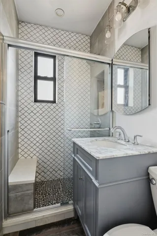 a bathroom with a sink toilet and shower