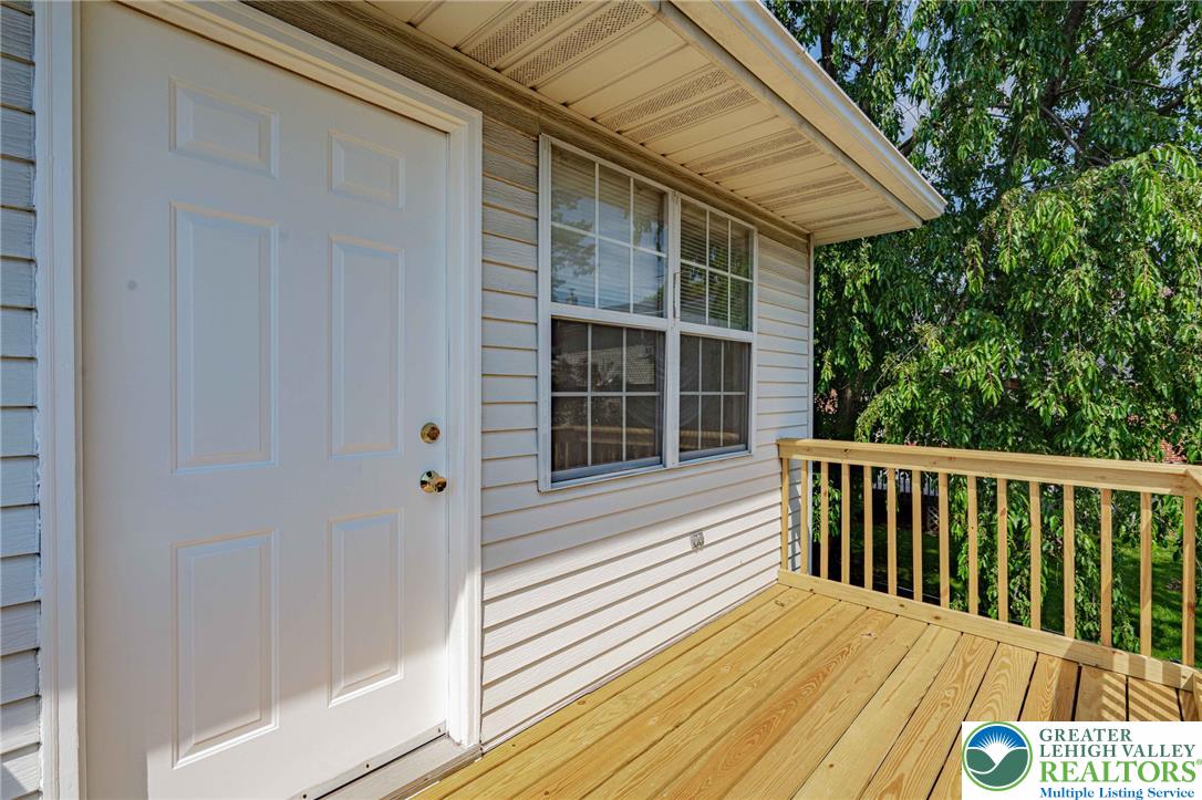 25 North 8th Street Emmaus, PA 18049 - Photo 40 of 51 A welcoming entry balcony extends from the residence, featuring durable wood decking and a classic white door.