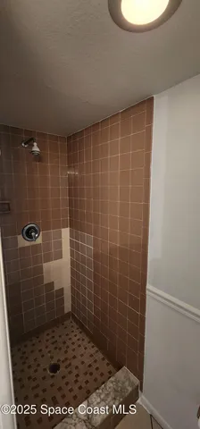 a view of yard with swimming pool and green space