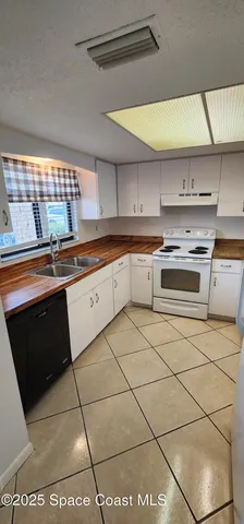 a kitchen with stainless steel appliances granite countertop a sink and a stove