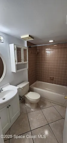 a bathroom with a toilet a sink and bathtub