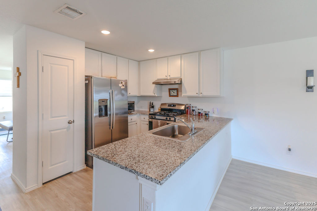 10502 Torroja Way Converse, TX 78109 - Photo 11 of 35 a kitchen with stainless steel appliances granite countertop a refrigerator a stove and a sink