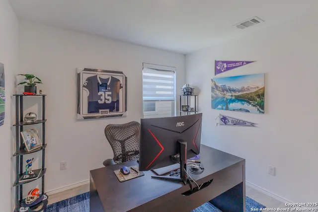 a view of a workspace with furniture and wooden floor
