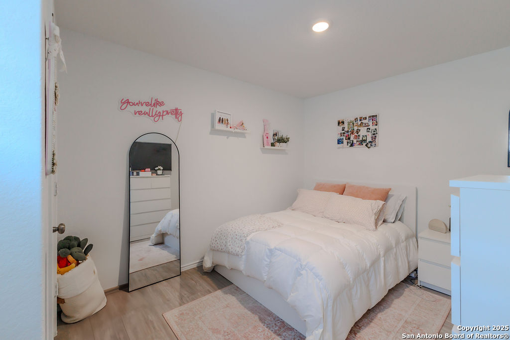 10502 Torroja Way Converse, TX 78109 - Photo 26 of 35 a bedroom with a bed and a potted plant