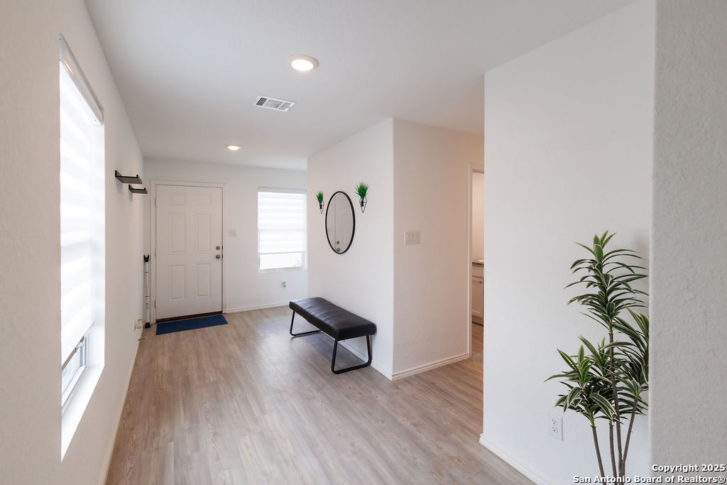 10502 Torroja Way Converse, TX 78109 - Photo 4 of 35 a view of a room with wooden floor and potted plant