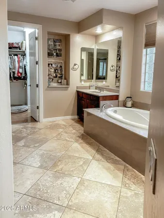 a large bathroom with a tub and sink