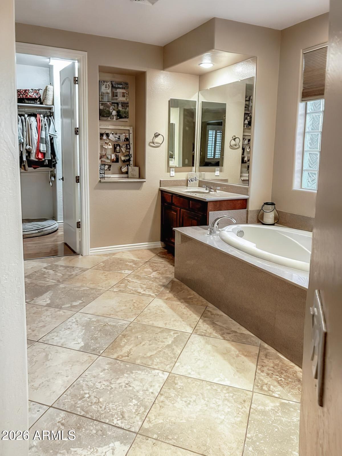 4450 South Rio Drive Chandler, AZ 85249 - Photo 19 of 29 a spacious bathroom with a granite countertop sink and a mirror