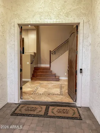a living room with furniture and large windows