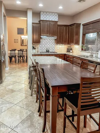 a kitchen with granite countertop a sink cabinets and stainless steel appliances