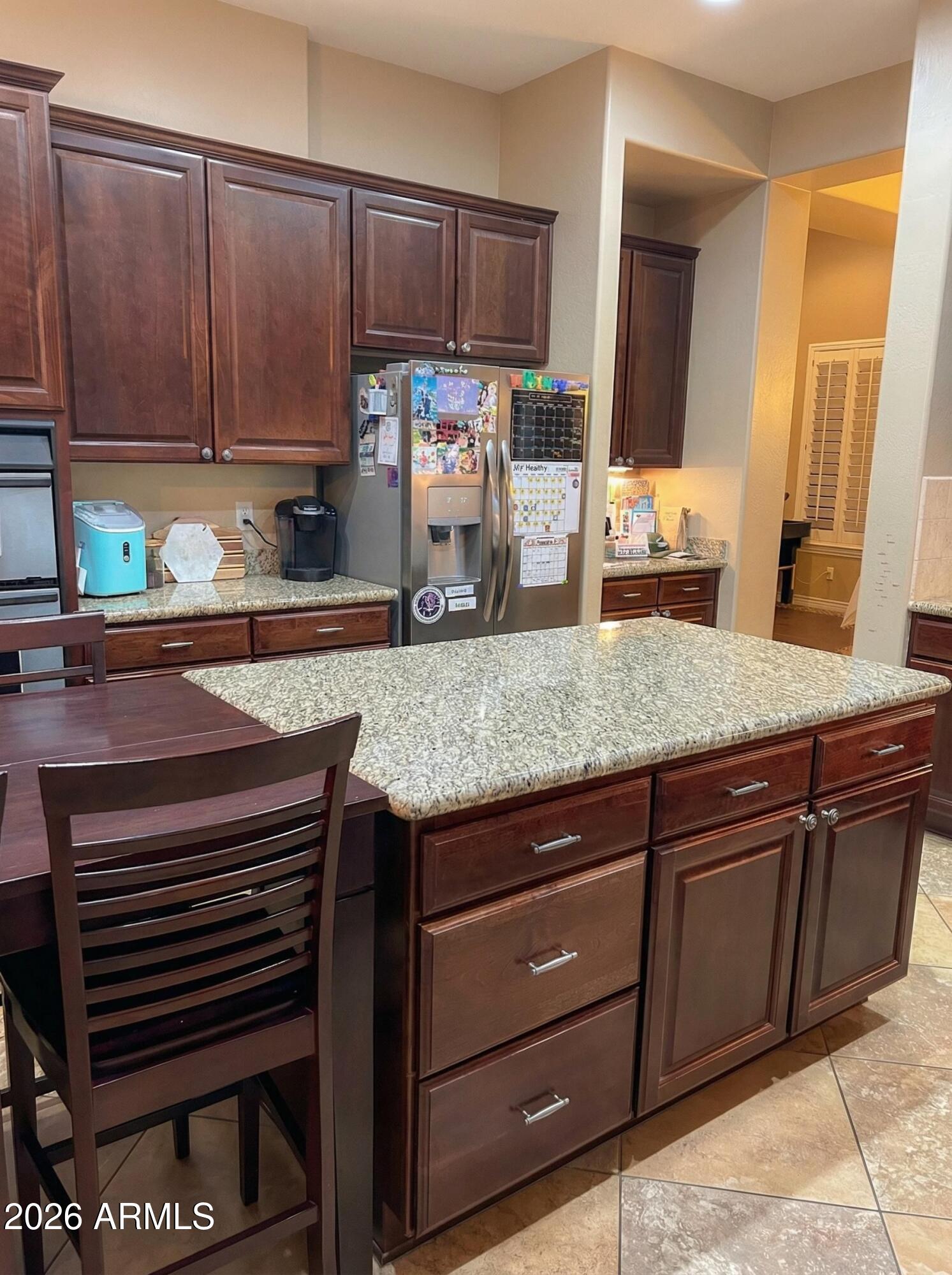 4450 South Rio Drive Chandler, AZ 85249 - Photo 8 of 29 a kitchen with granite countertop a sink cabinets and stainless steel appliances