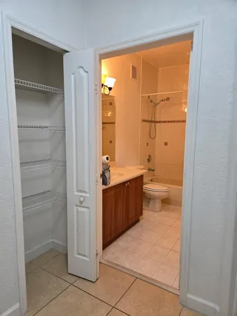 a bathroom with a granite countertop sink a toilet and shower