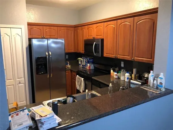 a kitchen with a refrigerator and a sink