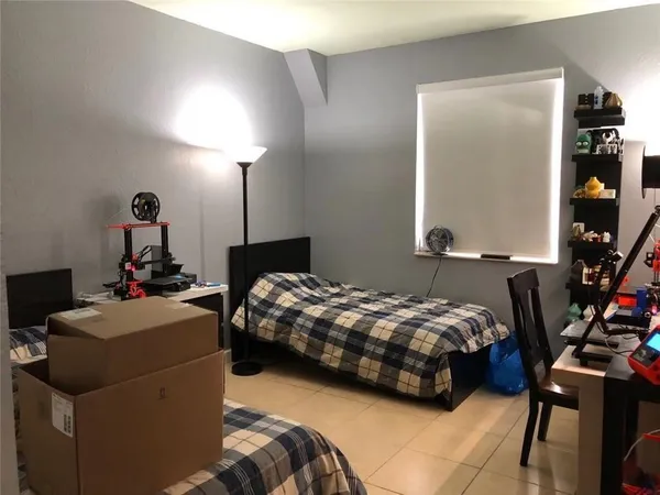 a bedroom with bed and a window