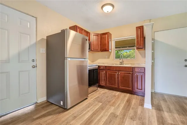 a kitchen with stainless steel appliances a refrigerator and a stove